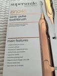Supersmile ZINA45 Electric Toothbrush Chrome Collection -new Bronze. Fixed Price $119.99.