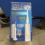 Miracle Smile Sonic Toothbrush, 5 Speeds, Usb Charging Dock, 6 Heads. Fixed Price $135.00.