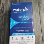 Waterpik Cordless Pearl Rechargeable Portable Flosser With 4 Piks. Fixed Price $21.00.